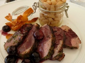 Petits filets de porc Cinta de Sienne, gratinés aux herbes des champs, servis avec une sauce au Sangiovese et des haricots à écosser en verre