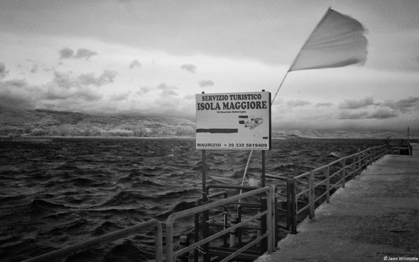 Le point d'amarrage du "bateau-taxi" pour l'Isola Maggiore.Signore Maurizio : 335-561.94.09.Action violente du vent sur le drapeau !